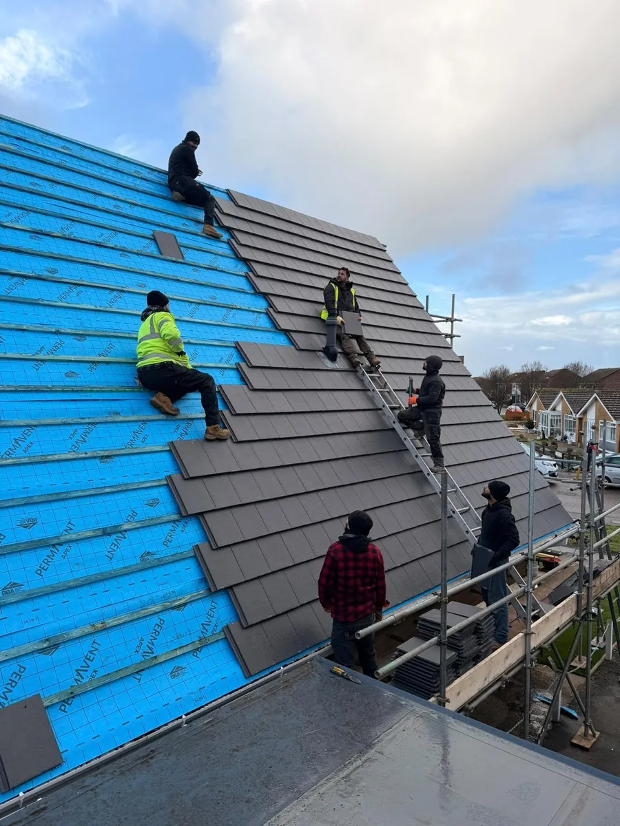 Team tiling over new blue breathable membrane