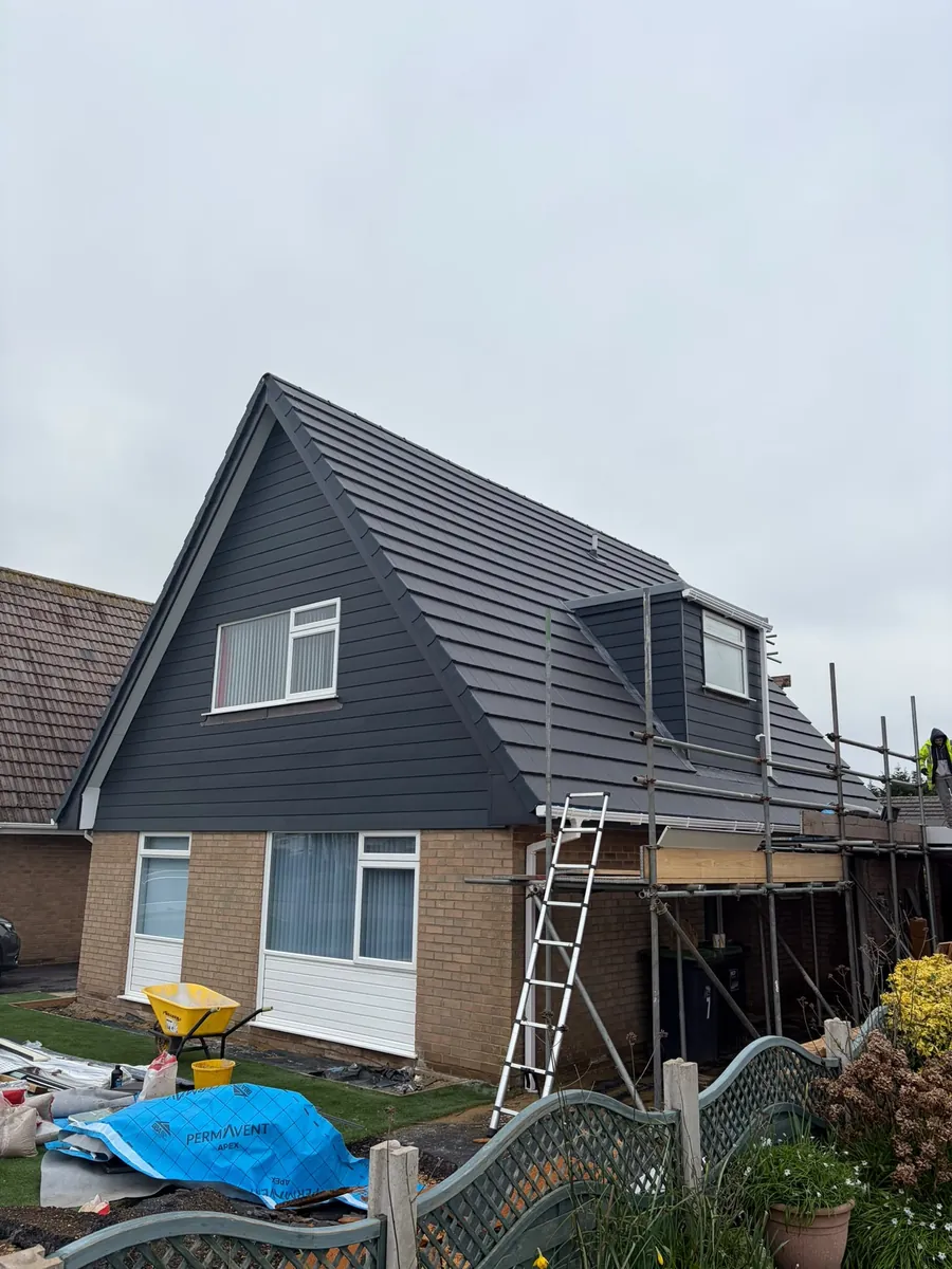 Chalet re-roof with new tiles and dark cladding