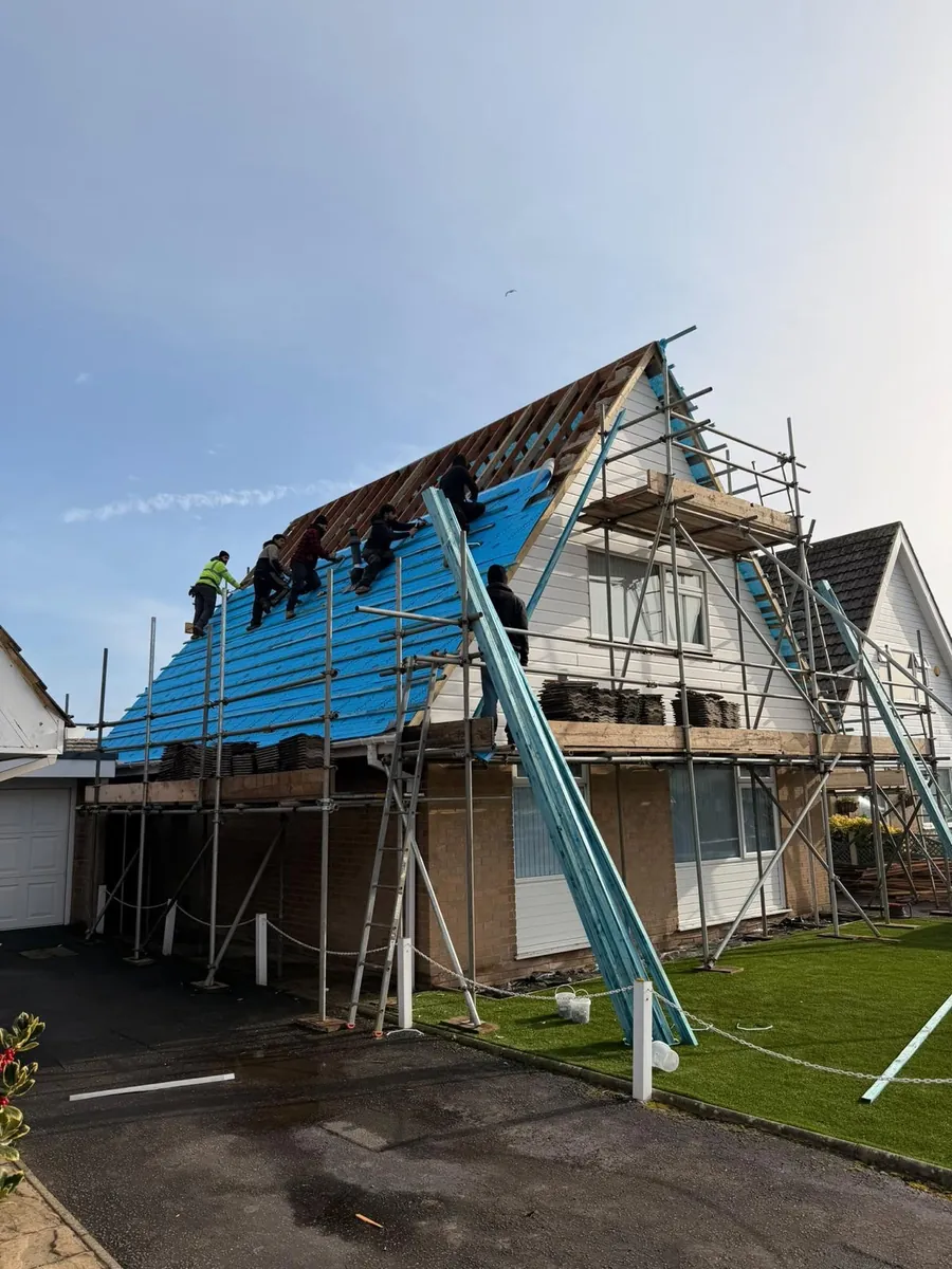 Old tiles stripped from a chalet roof under scaffold