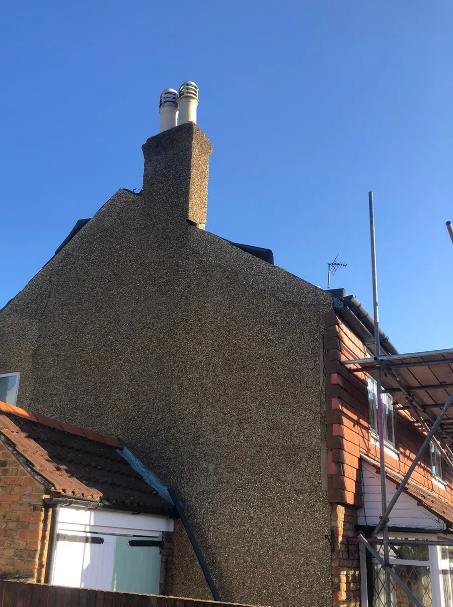 Chimney stack on a rendered gable