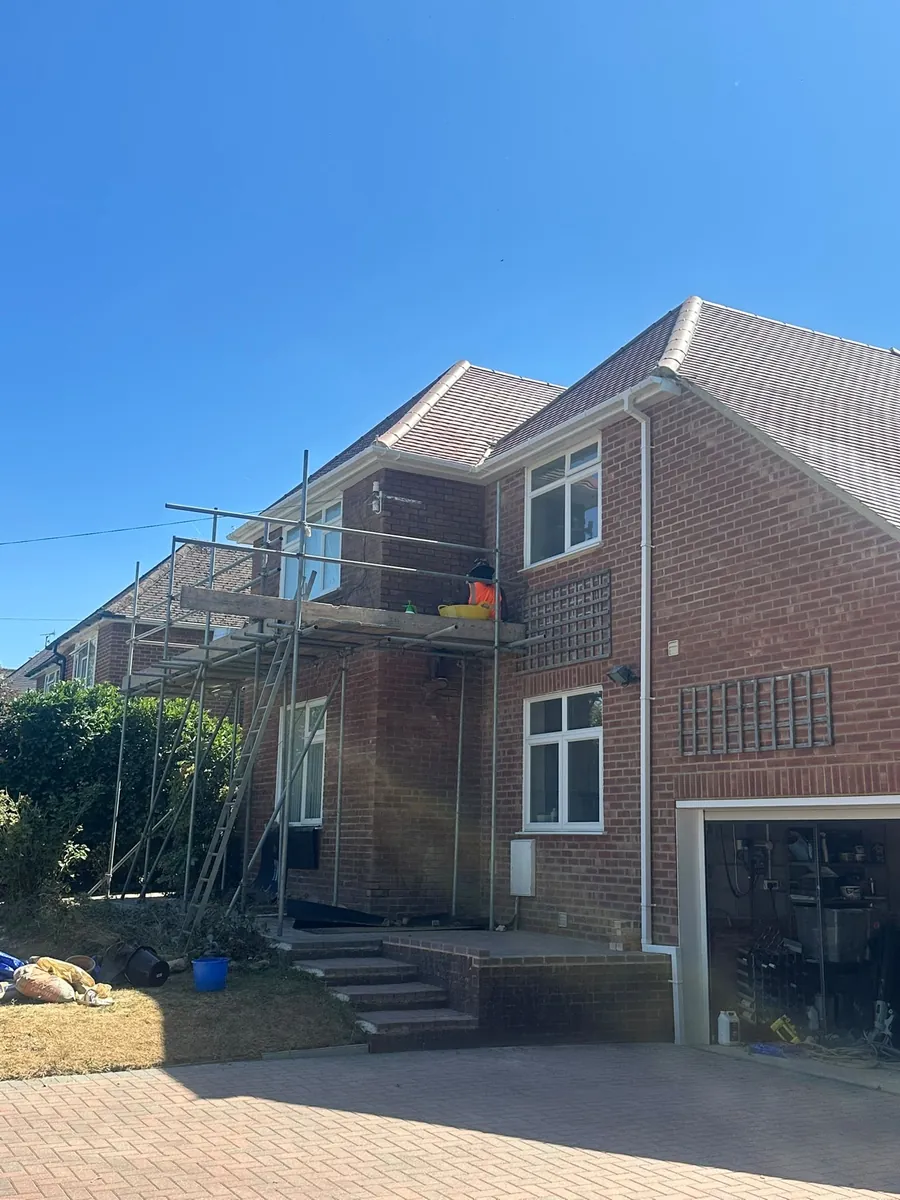 Detached house with scaffold up for roof work