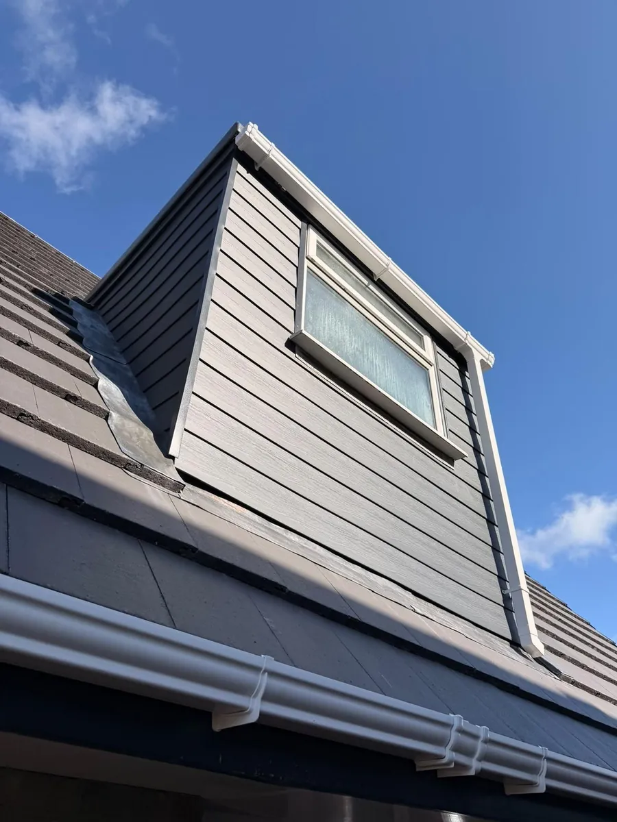 Finished dormer with grey cladding and a new gutter