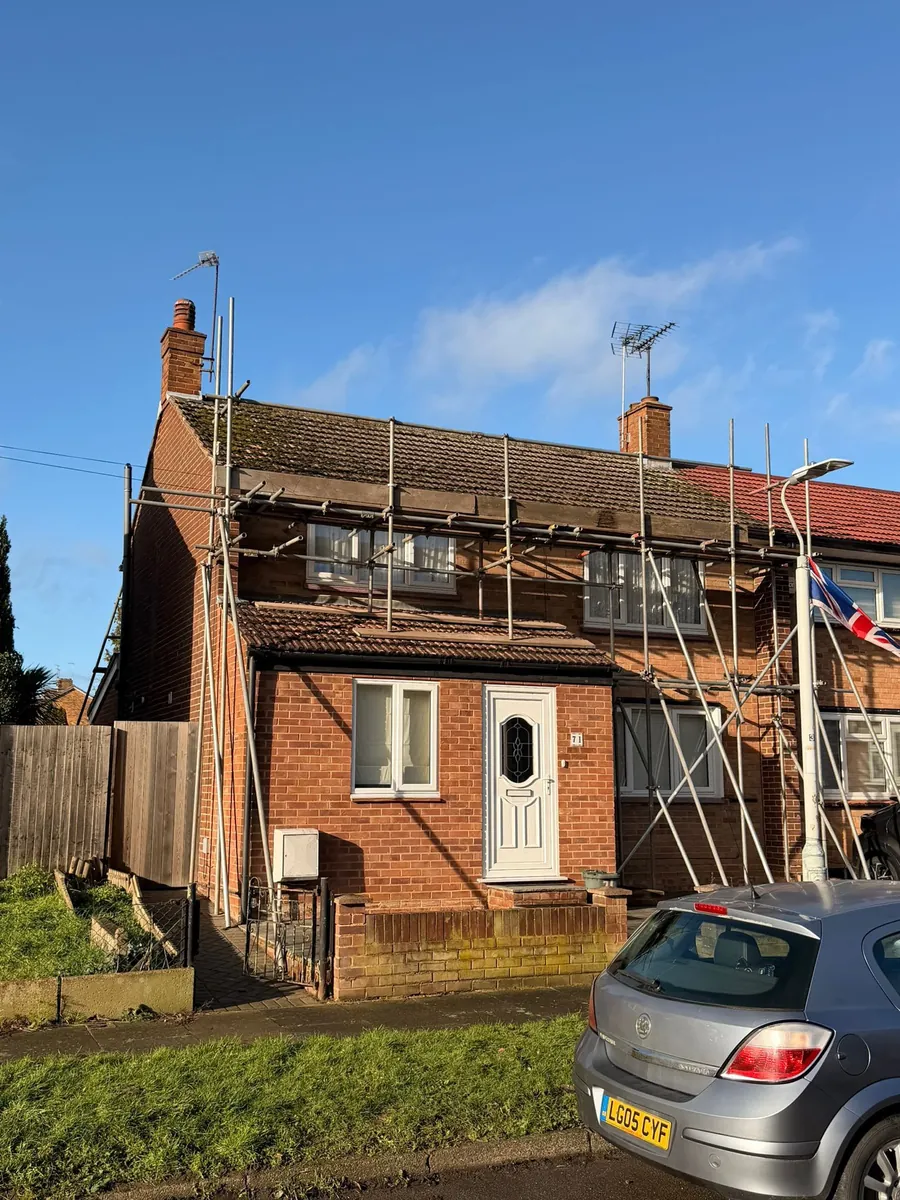End-of-terrace house under scaffold for roof work