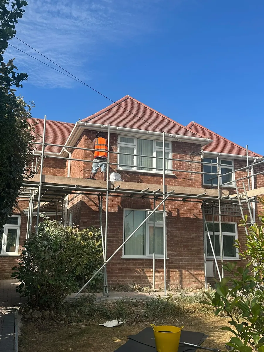 Front of a house under scaffold for roof work