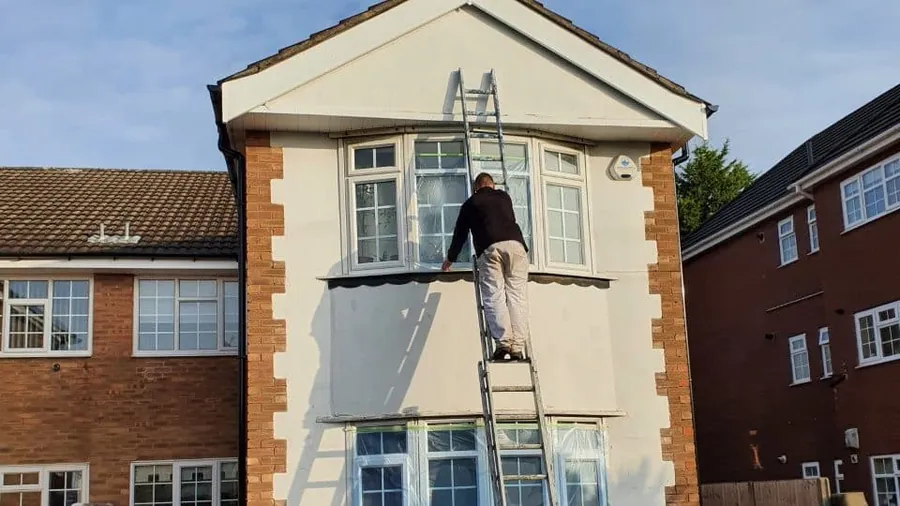 Painting a rendered gable from a ladder