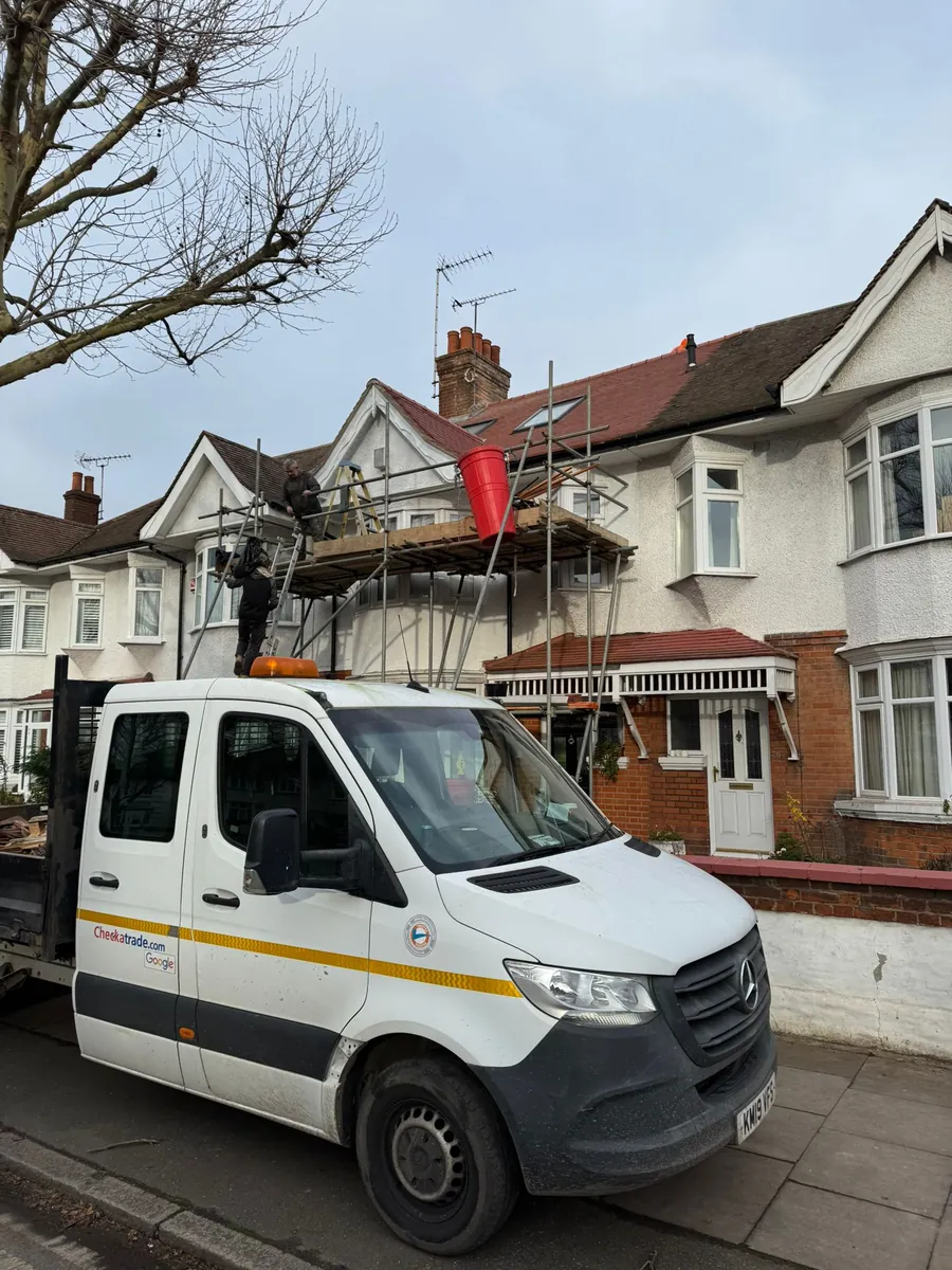 Pickup outside a house under scaffold