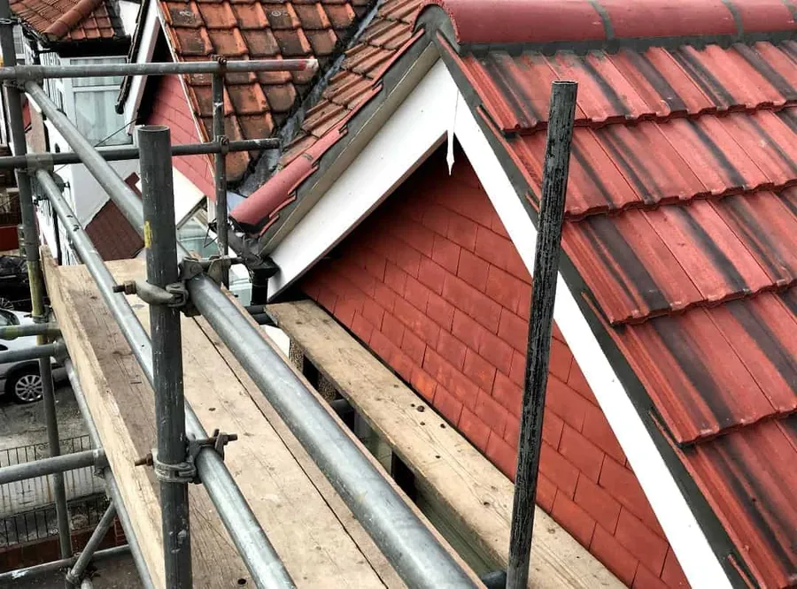 Red tiles around a dormer, seen from the scaffold