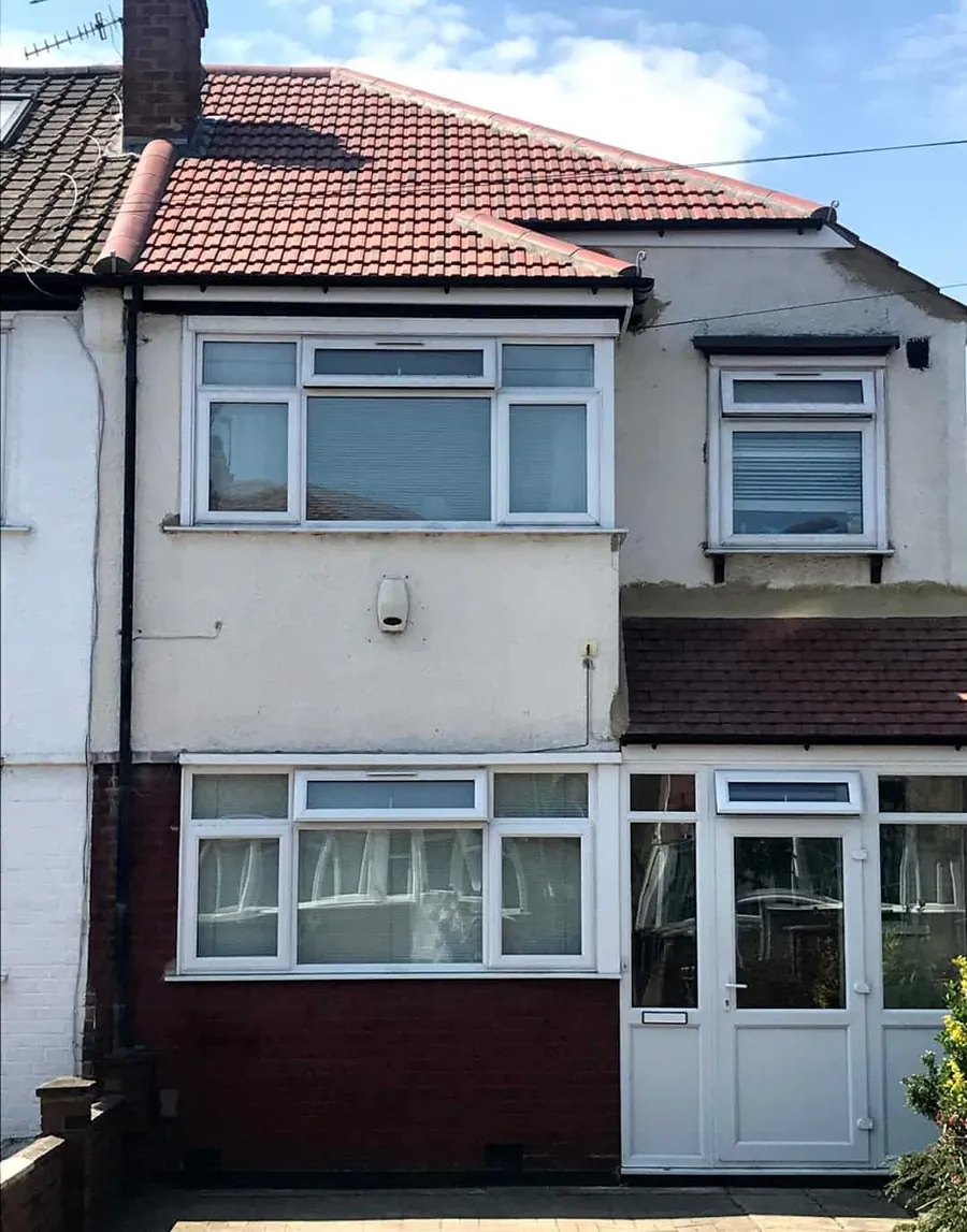 Finished red tile roof on an end-of-terrace house