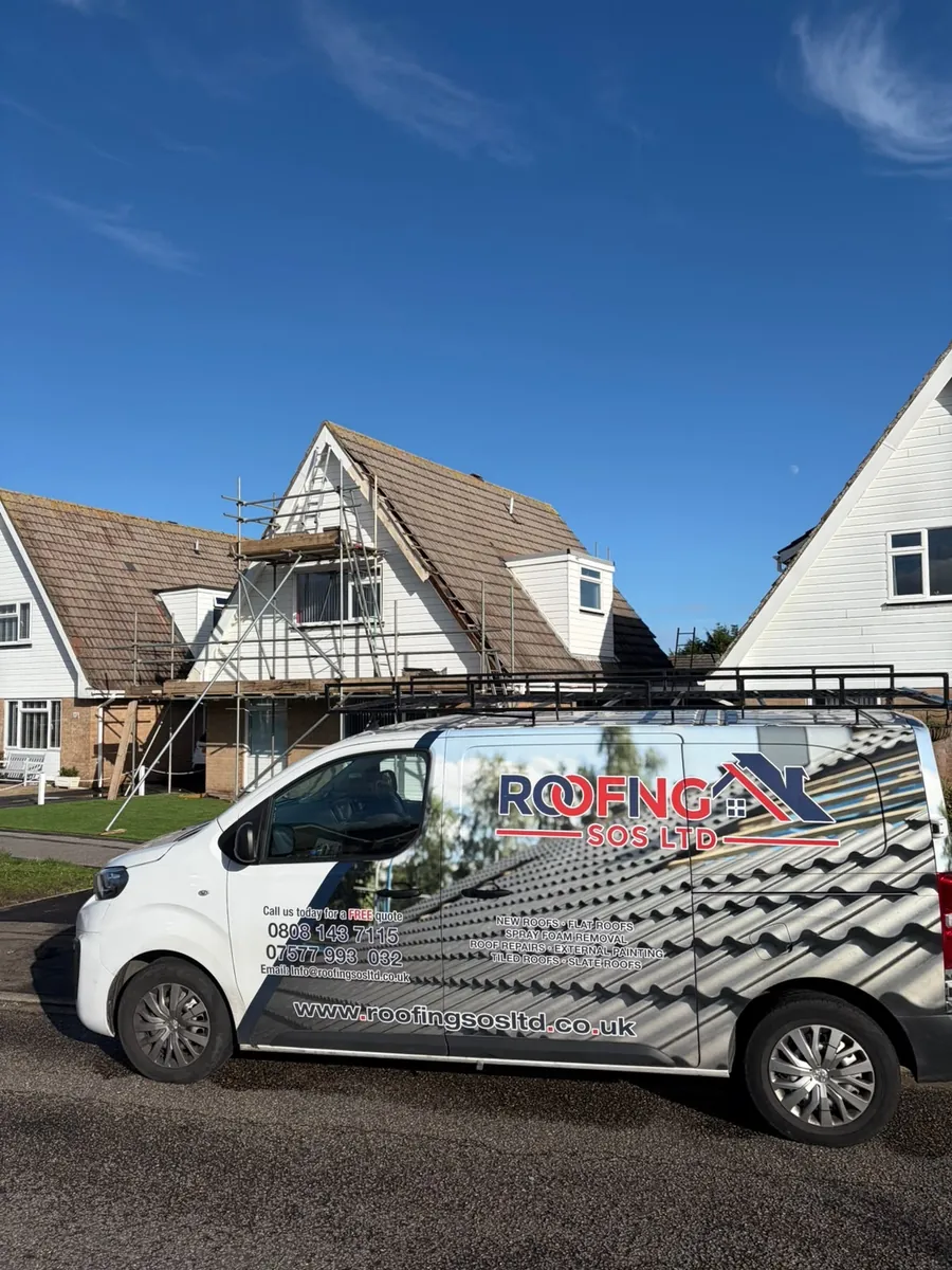 Roofing SOS Ltd van parked at a chalet re-roof