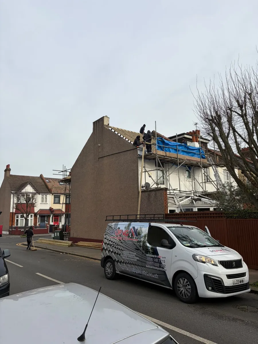 Roofing SOS Ltd van outside a job on a terraced street