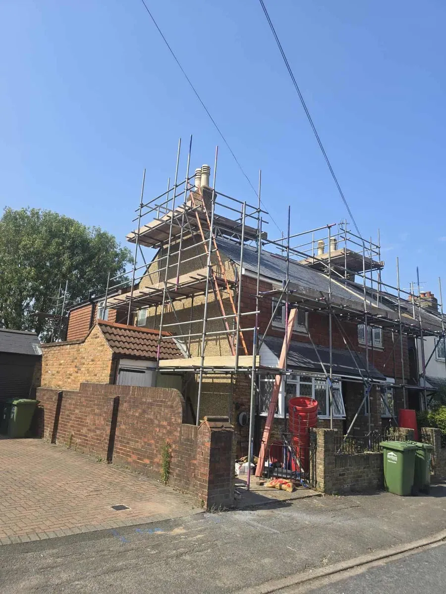 House wrapped in scaffold for render work
