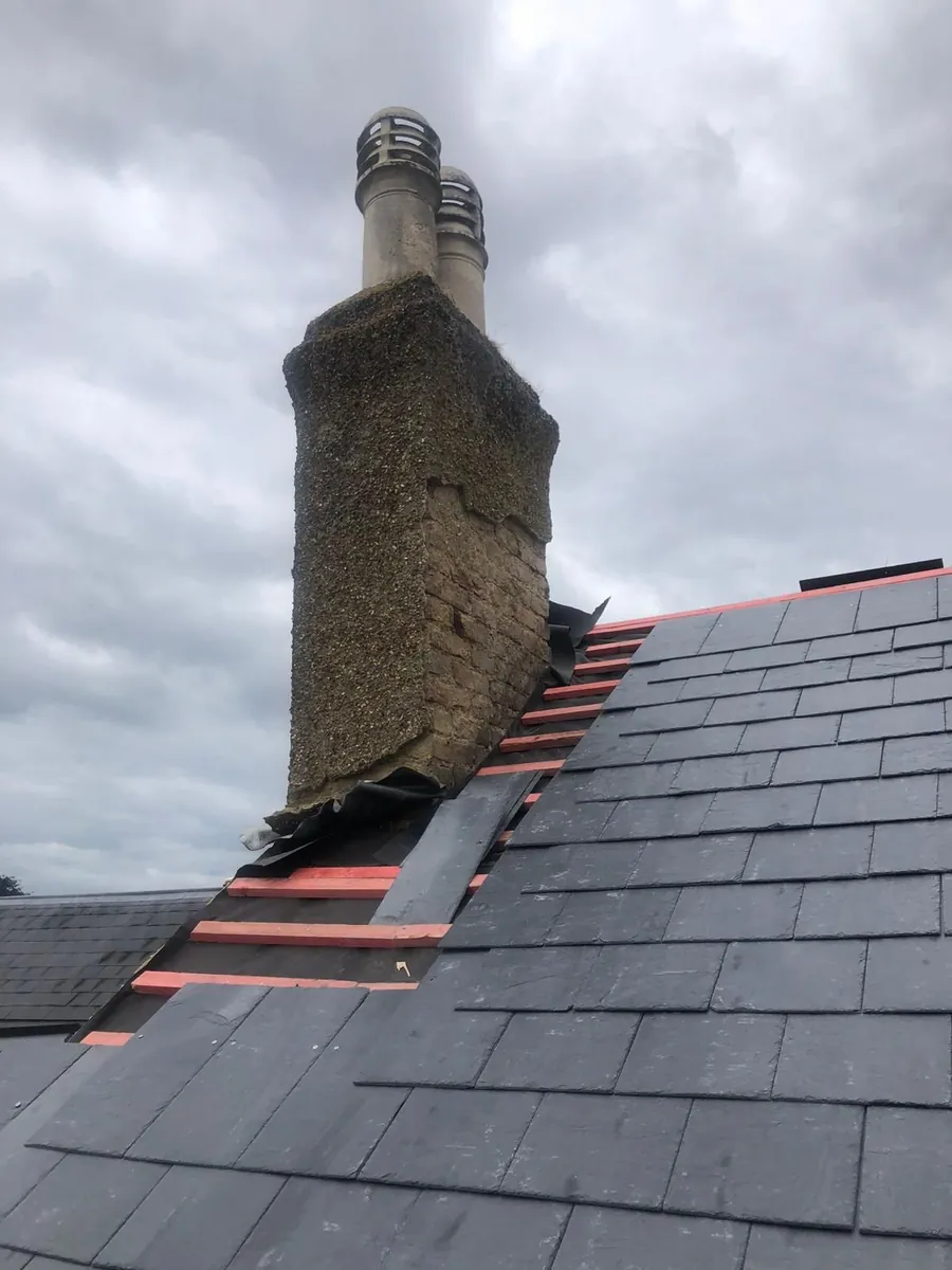 New slates laid up to a brick chimney stack
