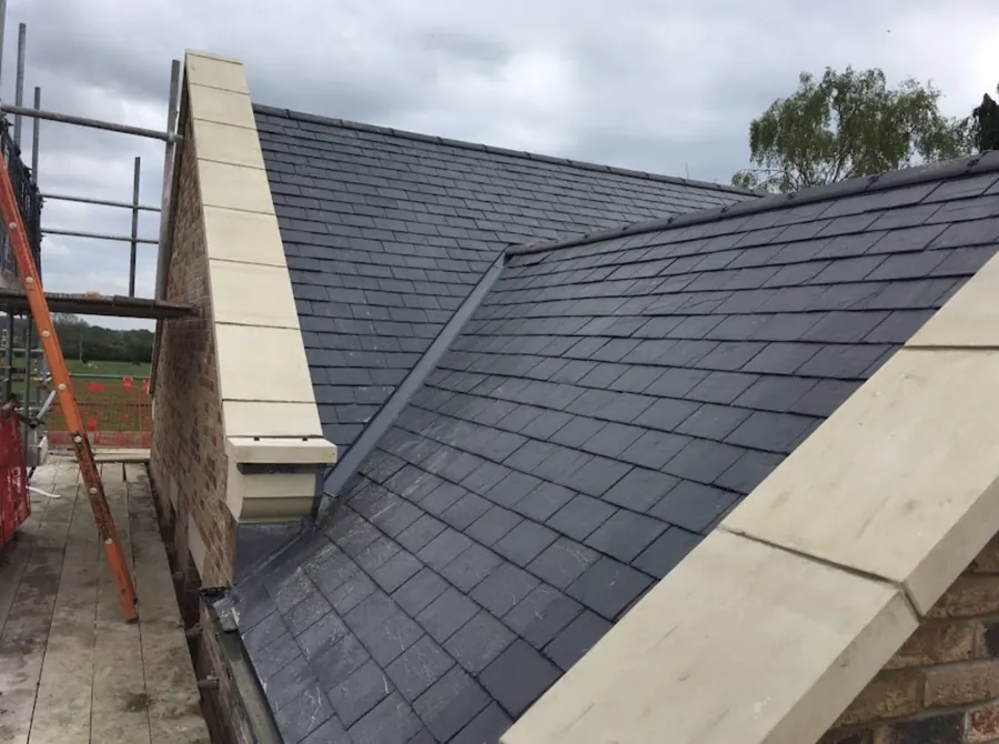 Slate slope finished against a stone parapet coping
