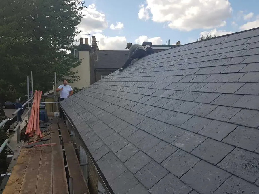 New slate slopes either side of a scaffold walkway