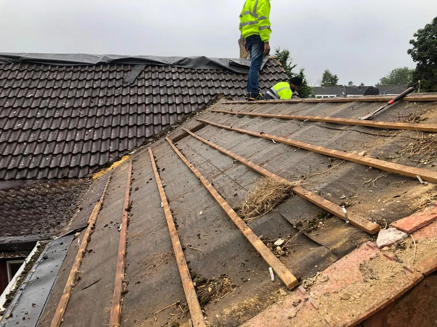 Old tiles coming off down to the battens