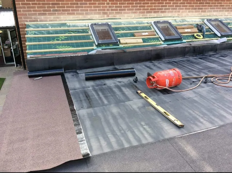 Torch-on felt flat roof going down below three roof windows