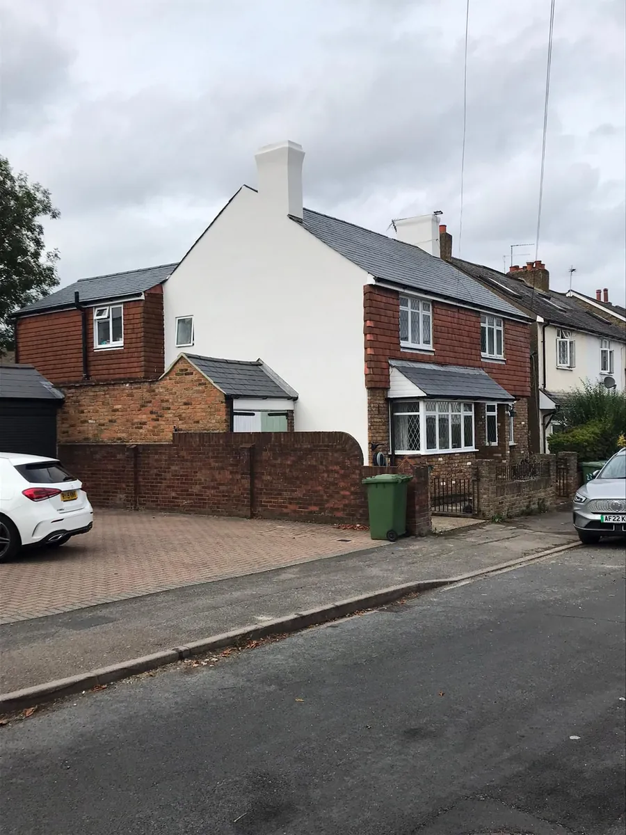 New grey roof on a white rendered house